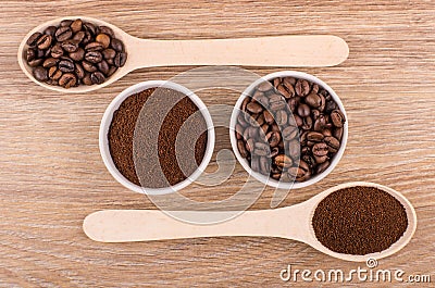 Spoon and bowls with ground coffee and roasted coffee beans Stock Photo