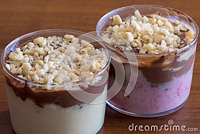 Spoon cake with two creams and almonds, two desserts in transparent glasses Stock Photo