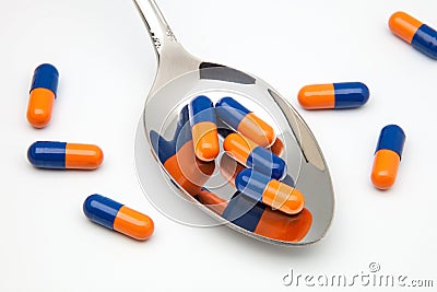 Spoon with capsulas medicas Stock Photo