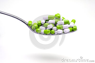 Spoon with capsules Stock Photo