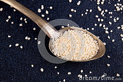 Spoon of couscous on dark background Stock Photo