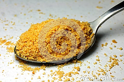 A spoon of delicious yellow cookie powder Stock Photo