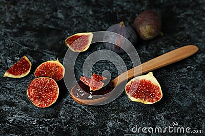 Spoon with fig jam and ingredients on black smokey background Stock Photo