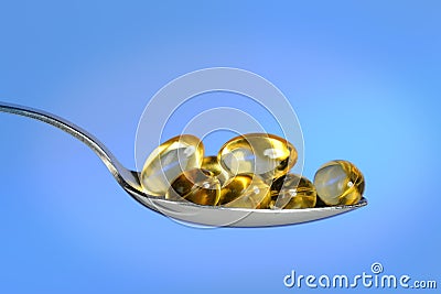 Spoon With Fish Oil Pills Stock Photo