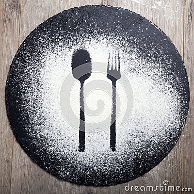 Spoon and fork silhouette made with flour on the dark texture background Stock Photo