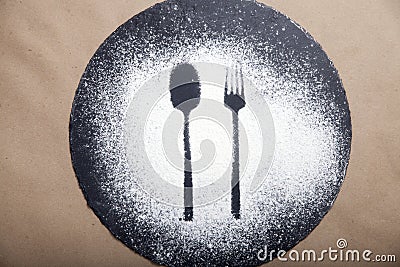 Spoon and fork silhouette made with flour on the dark texture background Stock Photo