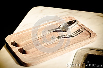 Spoon and fork on wooden tray in coffee shop Stock Photo