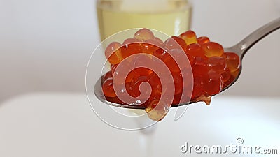 Spoon with red caviar and high glass of white vine Stock Photo