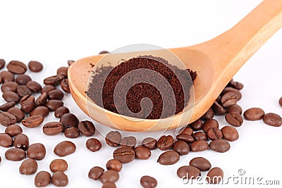 Spoon with ground coffee on beans Stock Photo