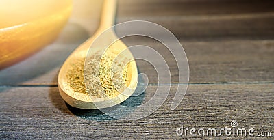 Spoon with Kava Kava root powder in wooden cup Stock Photo