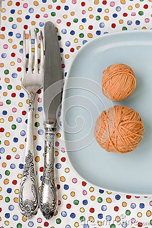 Spoon and knife lying on bright tablecloth Stock Photo