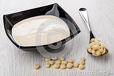 Spoon with oat bran, bowl with fruit yogurt, bran Stock Photo