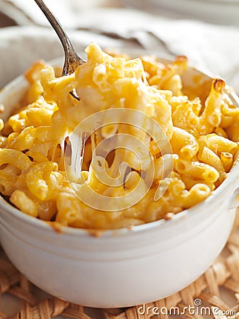 Spoon picking up macaroni and cheese Stock Photo
