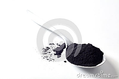 Spoon of round activated black plant charcoal Stock Photo