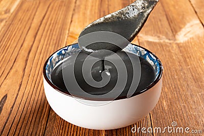 A spoon taking out black sesame paste Stock Photo