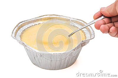 Spoon taking out fresh pudding Stock Photo