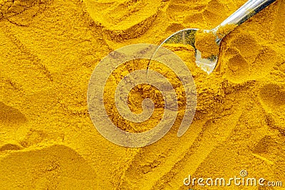 Spoon on turmeric powder seasoning Stock Photo