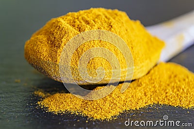 Spoon with turmeric powder Stock Photo