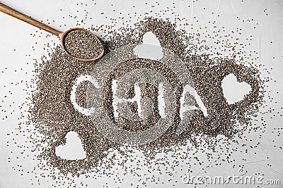 Spoon and word CHIA made of seeds on grey, flat lay Stock Photo