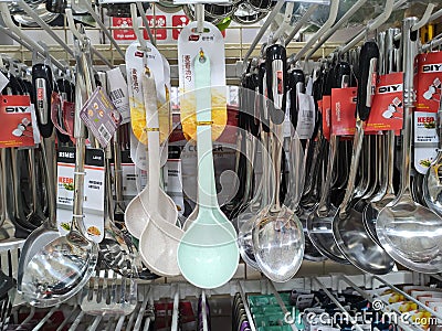 Spoons, ladles and other cooking utensils are hung and displayed for sale. Editorial Stock Photo