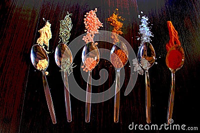 Spoons with spice on a dark surface Stock Photo