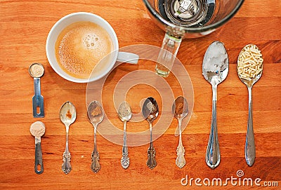 Spoons and spices to prepare a super coffee: a cup and a blender on a wooden chopping board with turmeric, black pepper, chili, Stock Photo