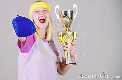 Sport achievement. Celebrate victory. Boxing champion. Athletic girl boxing glove and golden goblet. Woman wear sport Stock Photo