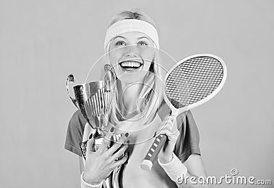 Sport achievement. Celebrate victory. Tennis champion. Athletic girl hold tennis racket and golden goblet. Win tennis Stock Photo