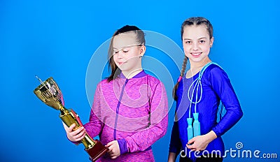 Sport achievement. Girls athletic kids celebrate victory. Athletic girls with golden goblet. Win championship. Our team Stock Photo