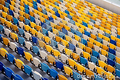 Sport arena empty tribune with colorful plastic seats. Stock Photo