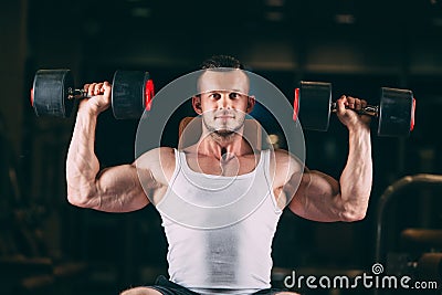 Sport, bodybuilding, weightlifting, lifestyle and people concept - young man with dumbbells flexing muscles in gym Stock Photo