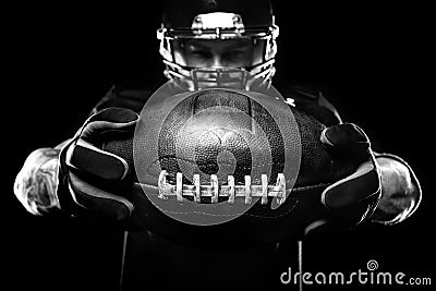 Sport concept. American football sportsman player on black background. Sport concept. Stock Photo