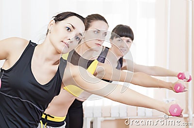 Sport Concepts. Three Caucasian Fit Women Performing Exercises Stock Photo