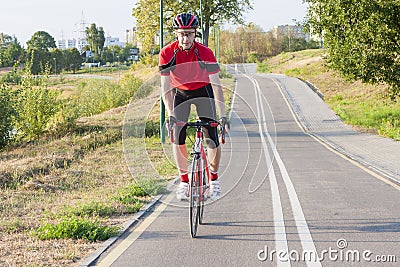 Sport and Cycling Ideas. Portrait of Professional Male Cyclist Stock Photo