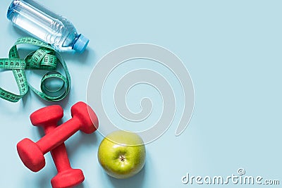 Sport equipment. Creative flat lay of sport and fitness equipments on blue with copy space. Stock Photo