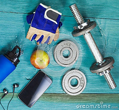 Sport Equipment. Dumbbells, Free Weights, Sport Gloves, Phone With Earphones Stock Photo