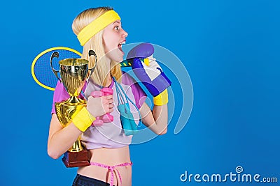 Sport equipment store. Sport for every day. Sport shop assortment. Girl successful modern woman hold golden goblet of Stock Photo