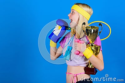 Sport equipment store. Sport for every day. Sport shop assortment. Girl successful modern woman hold golden goblet of Stock Photo