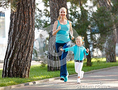 Sport family. Mother and baby daughter jogging run on nature Stock Photo
