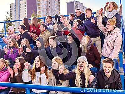 Sport fans clapping and singing on tribunes Stock Photo