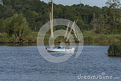 Sport fishing man in small boat West Oder river Szczecin Editorial Stock Photo