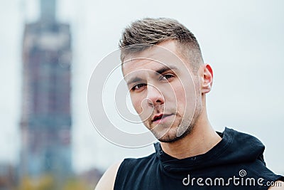 Sport fitness man posing against the backdrop of the city. Male athlete outside fall park. Fit model. Stock Photo