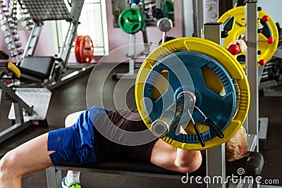 Man during bench press exercise in gym Stock Photo