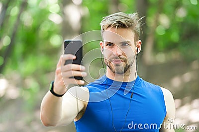 Sport gadget concept. Athlete mobile phone set up playlist before runnig. Man athlete busy face setting up smartphone Stock Photo