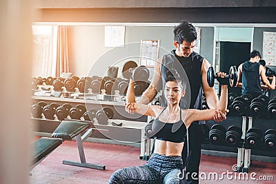 Sport girl doing weight exercises working with heavy dumbbells h Stock Photo