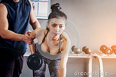 Sport girl doing weight exercises working with heavy dumbbells h Stock Photo