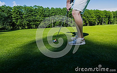 Sport Healthy. Golf game. Man golfer action win after long putting golf ball on green Stock Photo