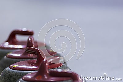 Sport Ideas and Concepts. Closeup of Curling Red Handle Stones o Stock Photo