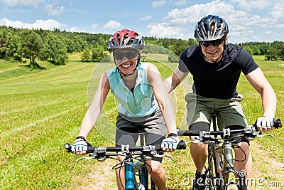 Sport mountain biking - man pushing young girl Stock Photo