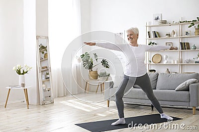 Sport On Retirement. Active Senior Woman Doing Pilates Workout At Home Stock Photo